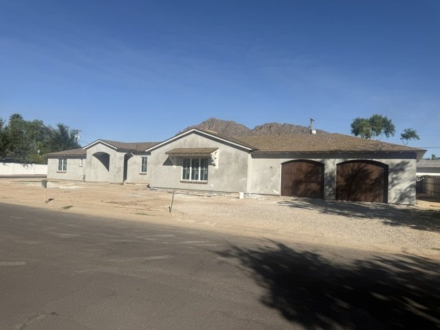 Residential stucco exterior at the brown-coat stage
