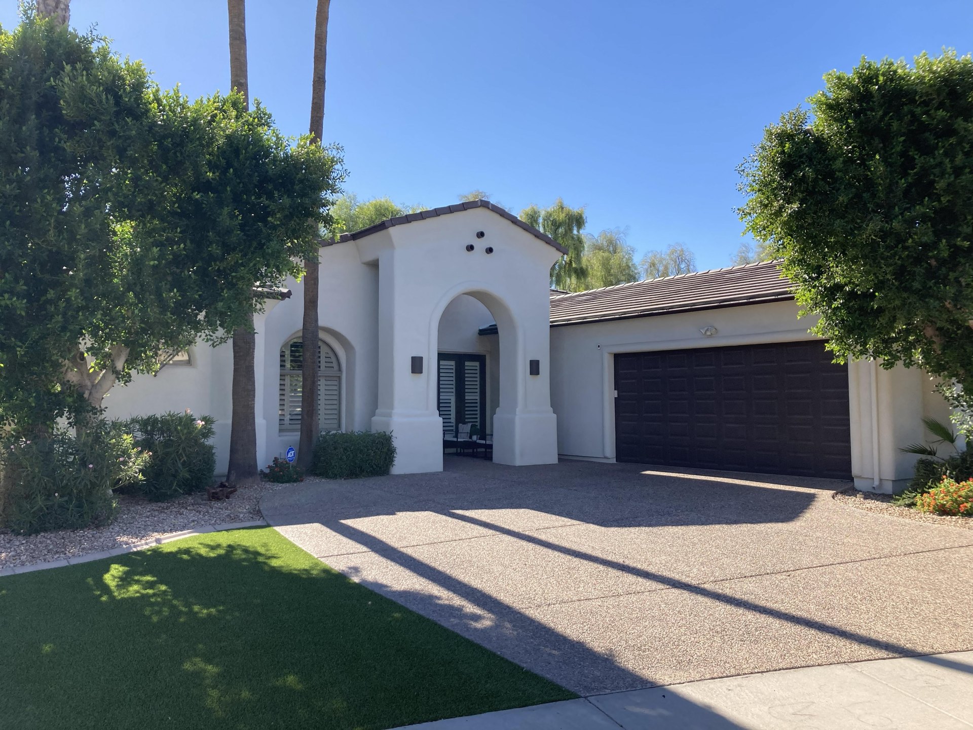 Completed residential home with a clean stucco exterior finish